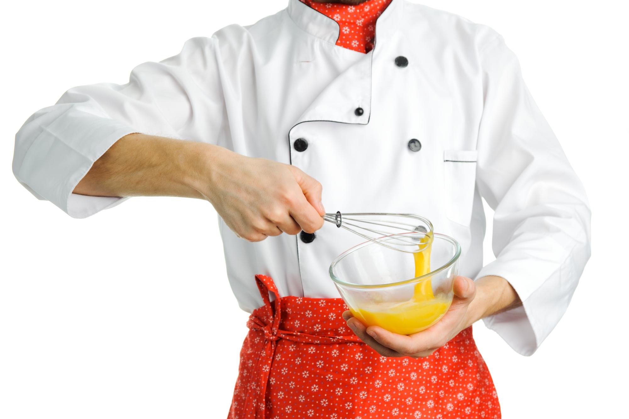 Chef finishing sauce with a brush